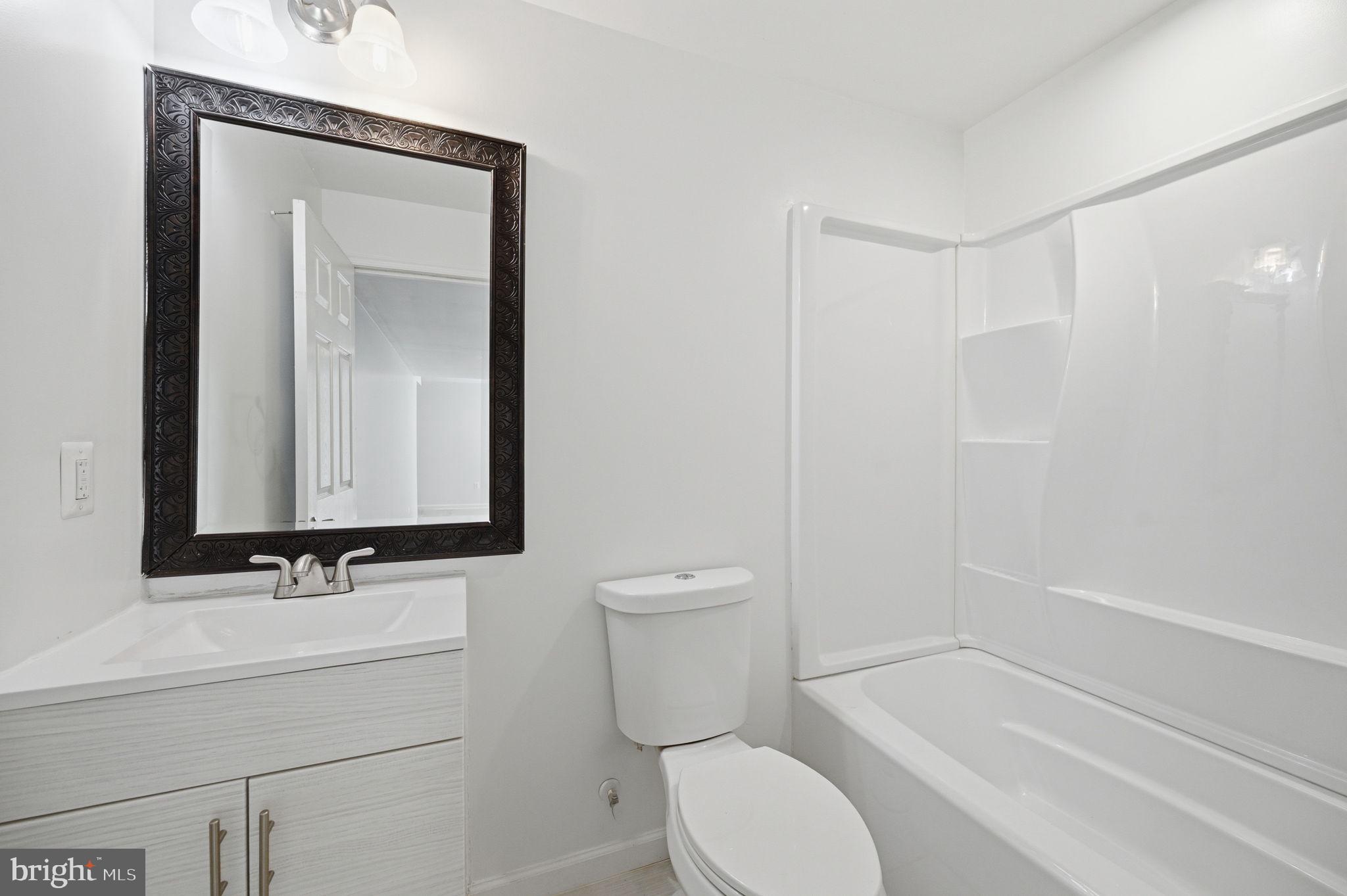 687 Blossom Tree Road Culpeper, VA 22701 - Photo 29 of 31 a bathroom with a sink a toilet and shower