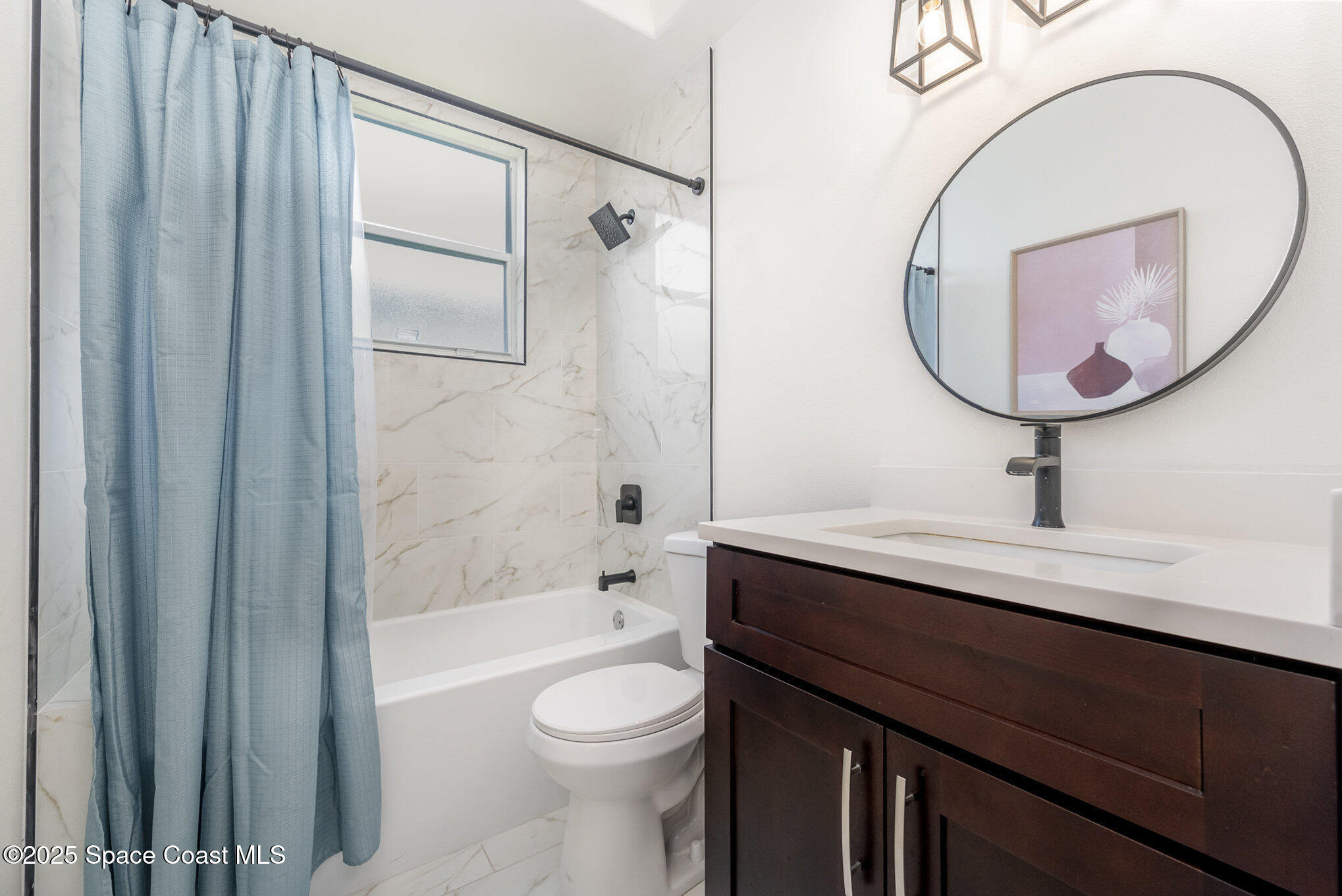 853 Villa Drive Melbourne, FL 32940 - Photo 11 of 26 a bathroom with a sink a toilet and a mirror