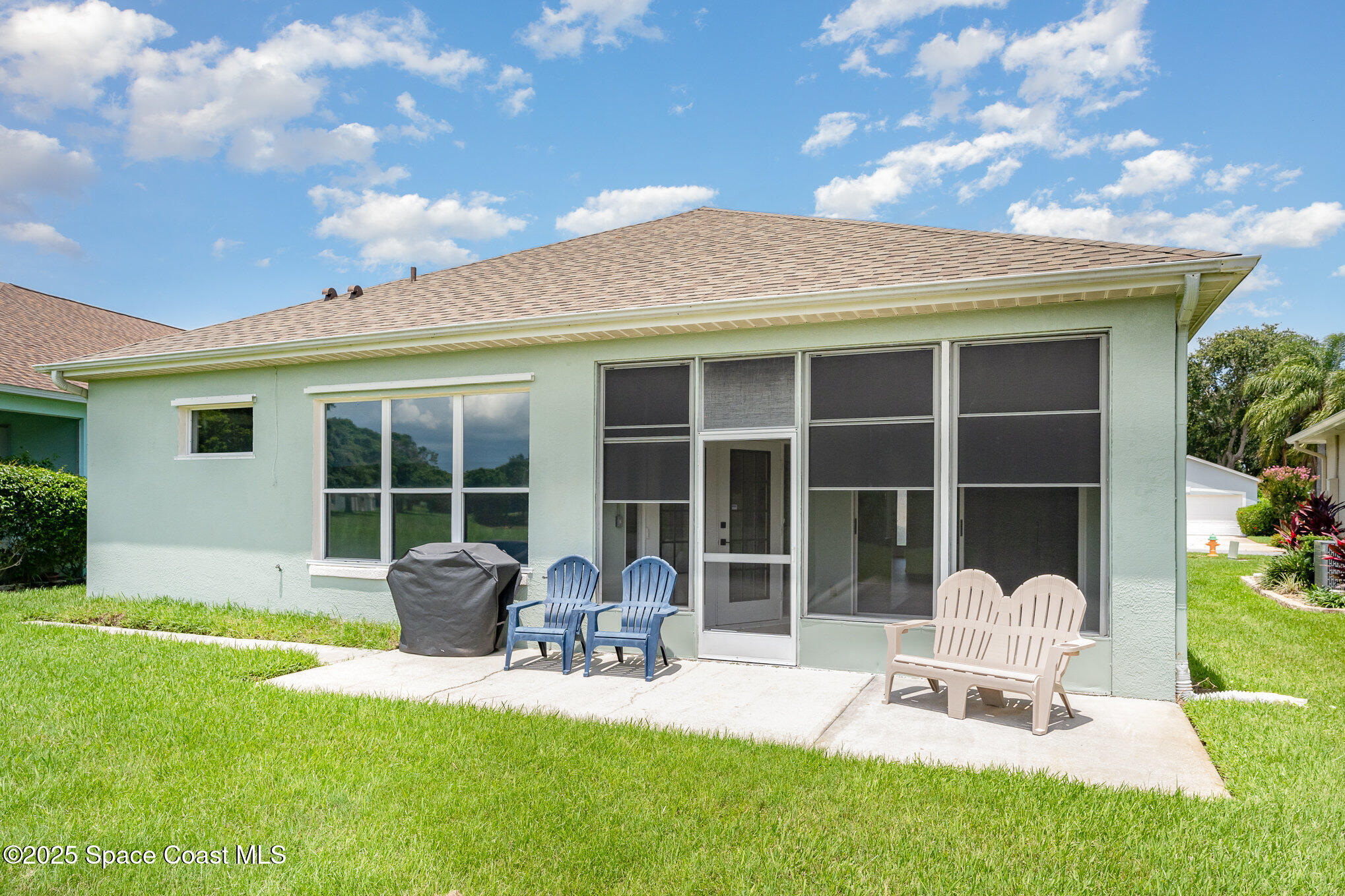 853 Villa Drive Melbourne, FL 32940 - Photo 14 of 26 a front view of a house with a garden and patio
