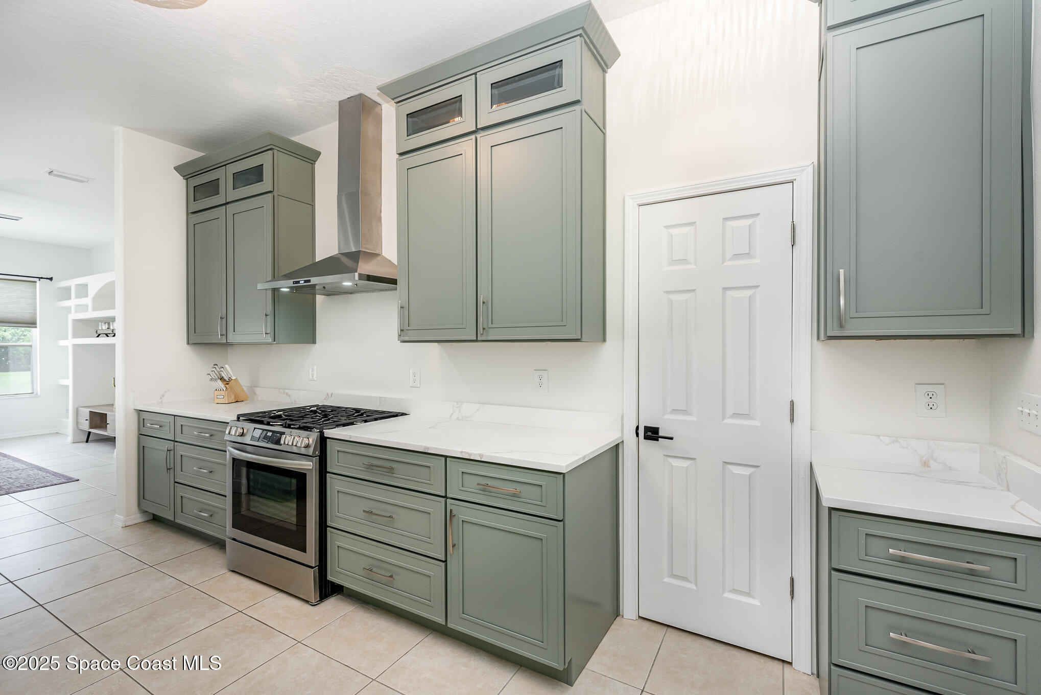 853 Villa Drive Melbourne, FL 32940 - Photo 17 of 26 a kitchen with stainless steel appliances granite countertop a stove and a refrigerator