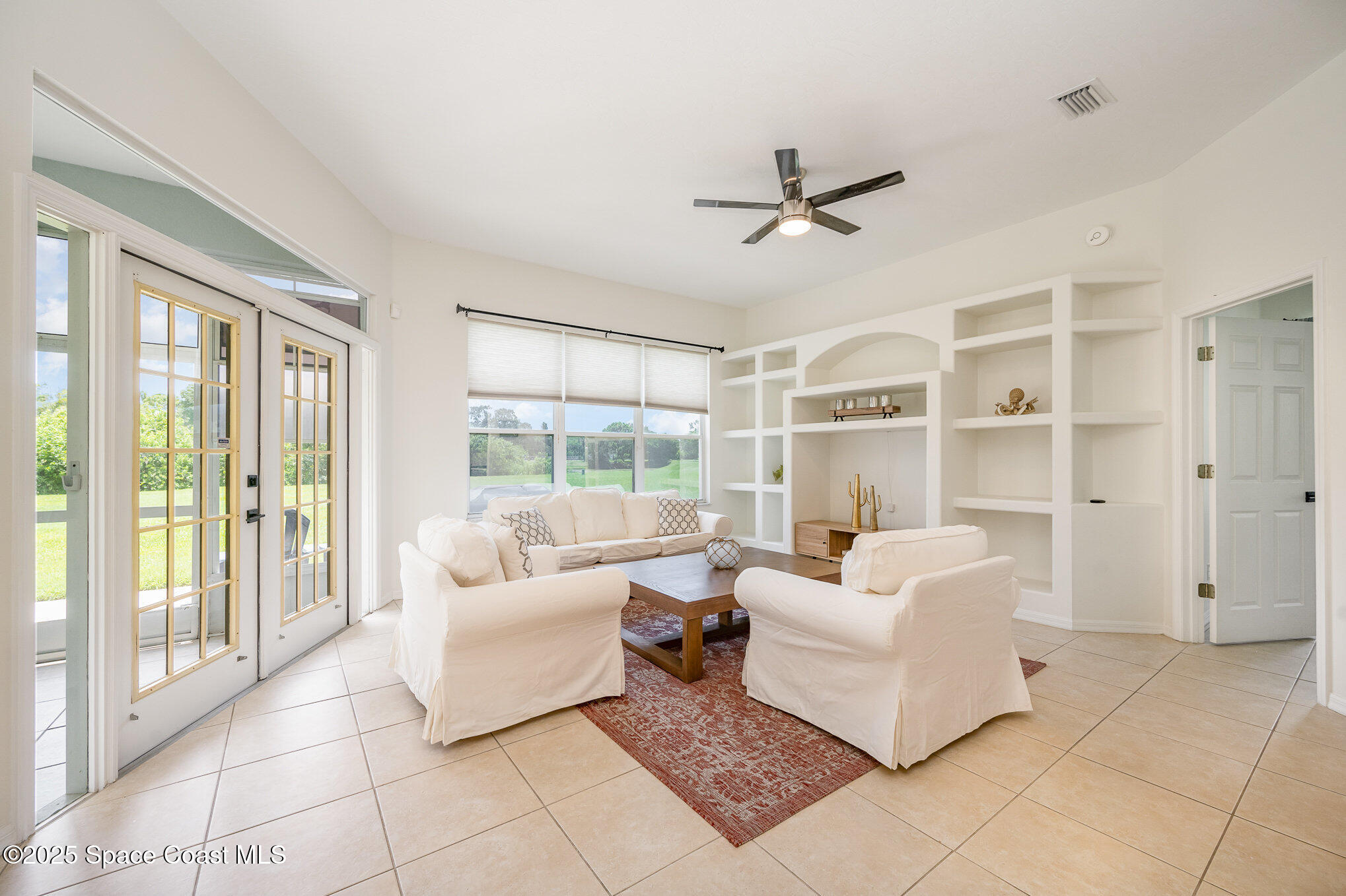 853 Villa Drive Melbourne, FL 32940 - Photo 18 of 26 a living room with furniture and a large window