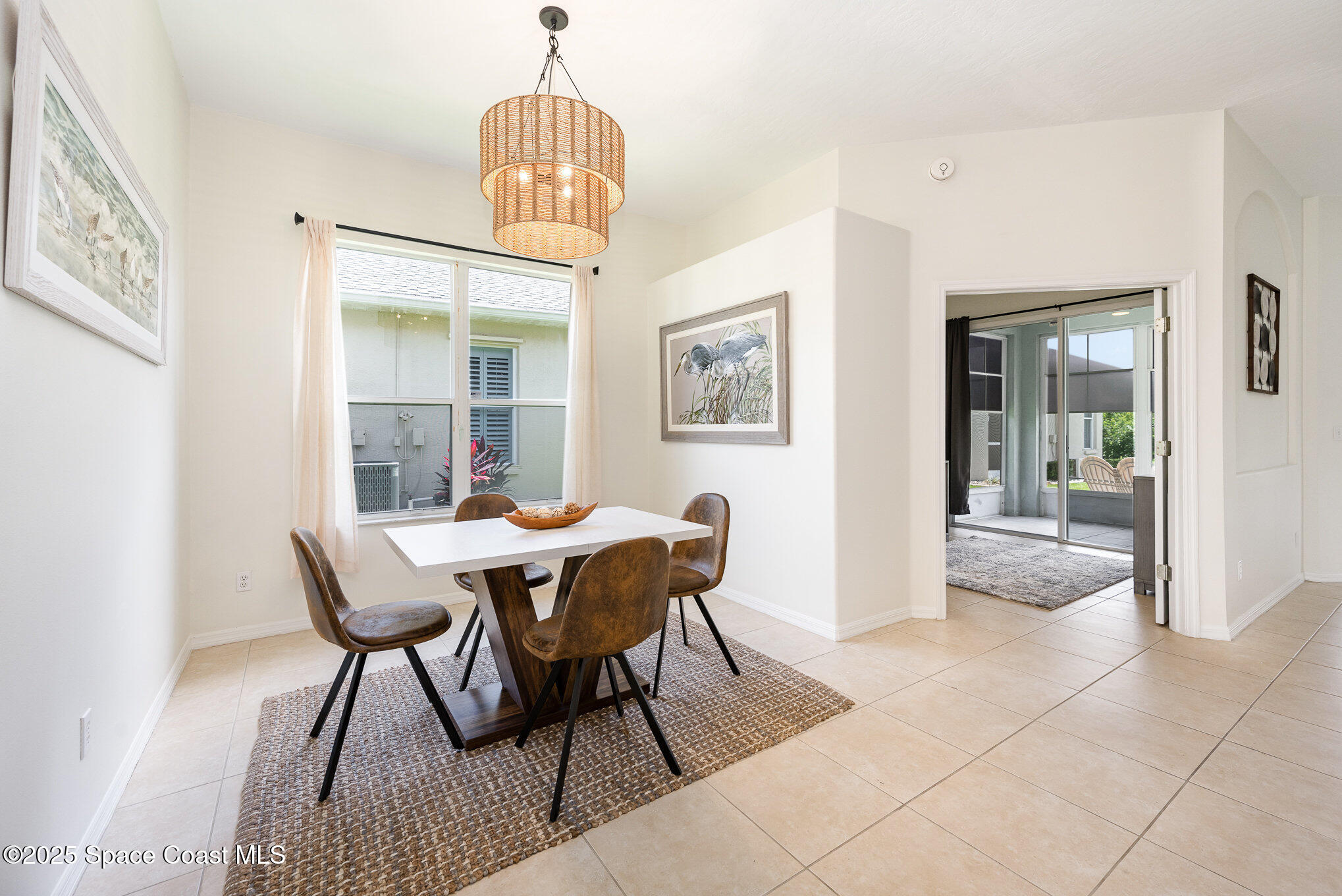 853 Villa Drive Melbourne, FL 32940 - Photo 20 of 26 a dining room with furniture a chandelier and wooden floor
