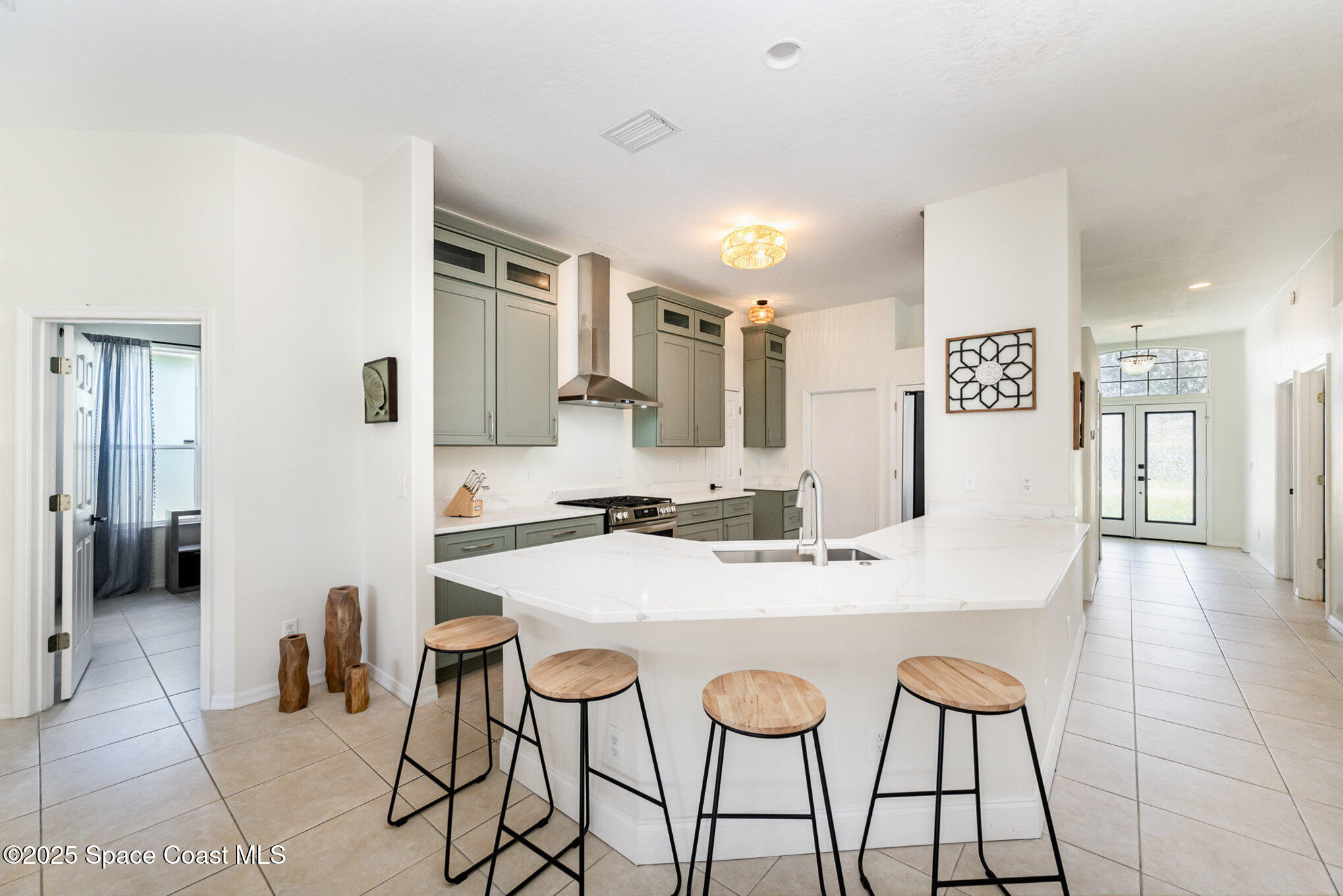853 Villa Drive Melbourne, FL 32940 - Photo 21 of 26 a large kitchen with a table and chairs