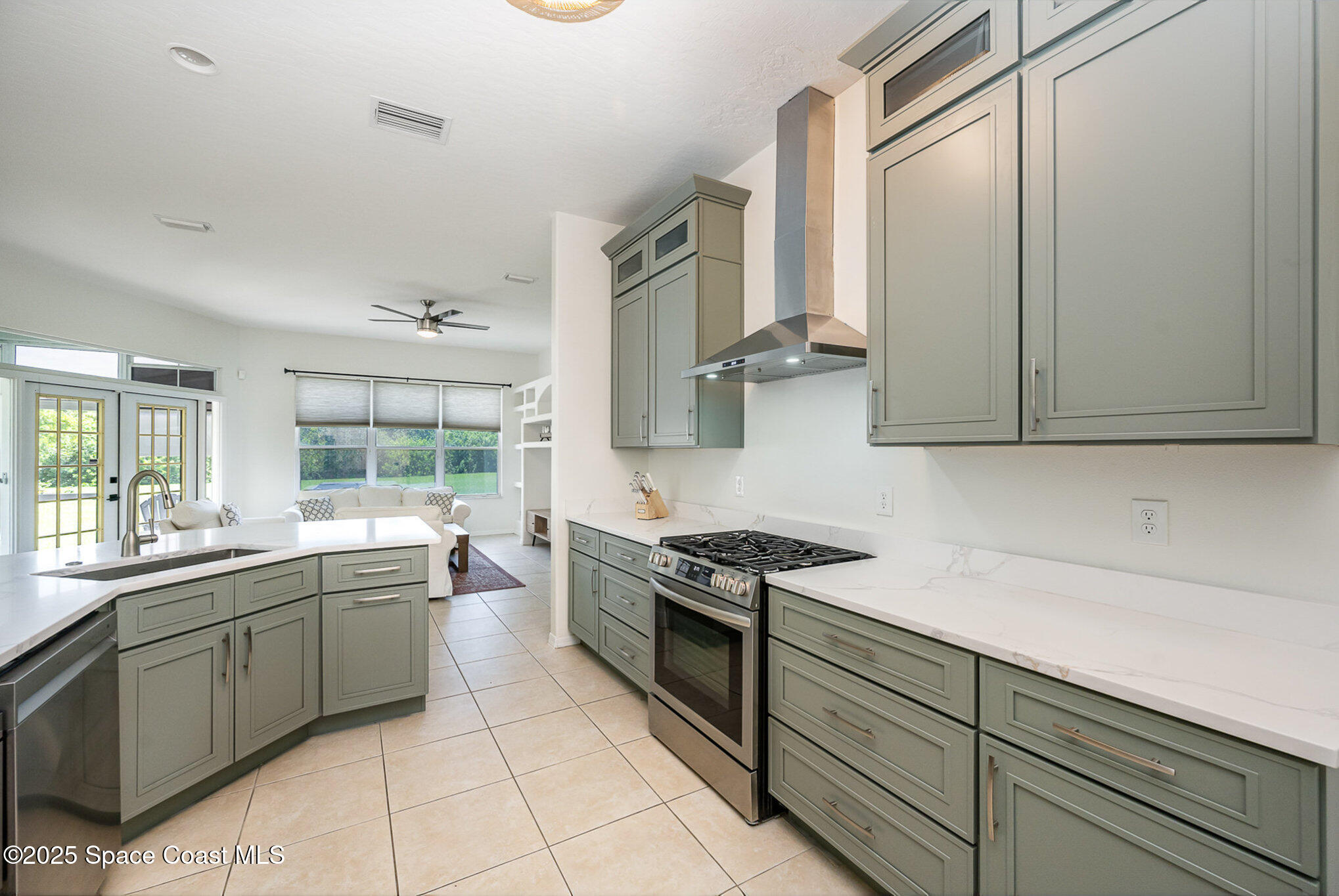 853 Villa Drive Melbourne, FL 32940 - Photo 4 of 26 a kitchen with a sink and cabinets