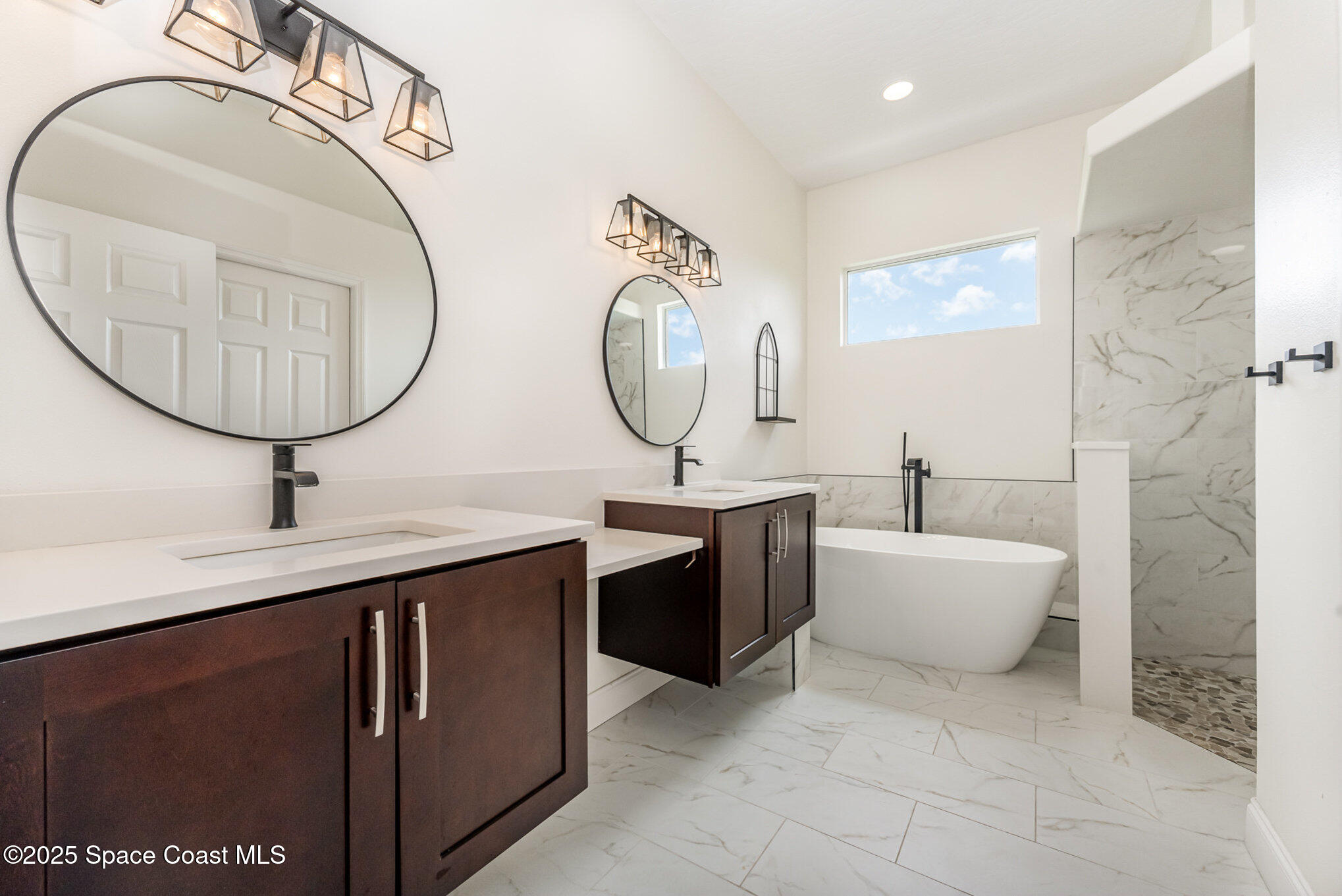 853 Villa Drive Melbourne, FL 32940 - Photo 8 of 26 a spacious bathroom with a double vanity sink and a mirror