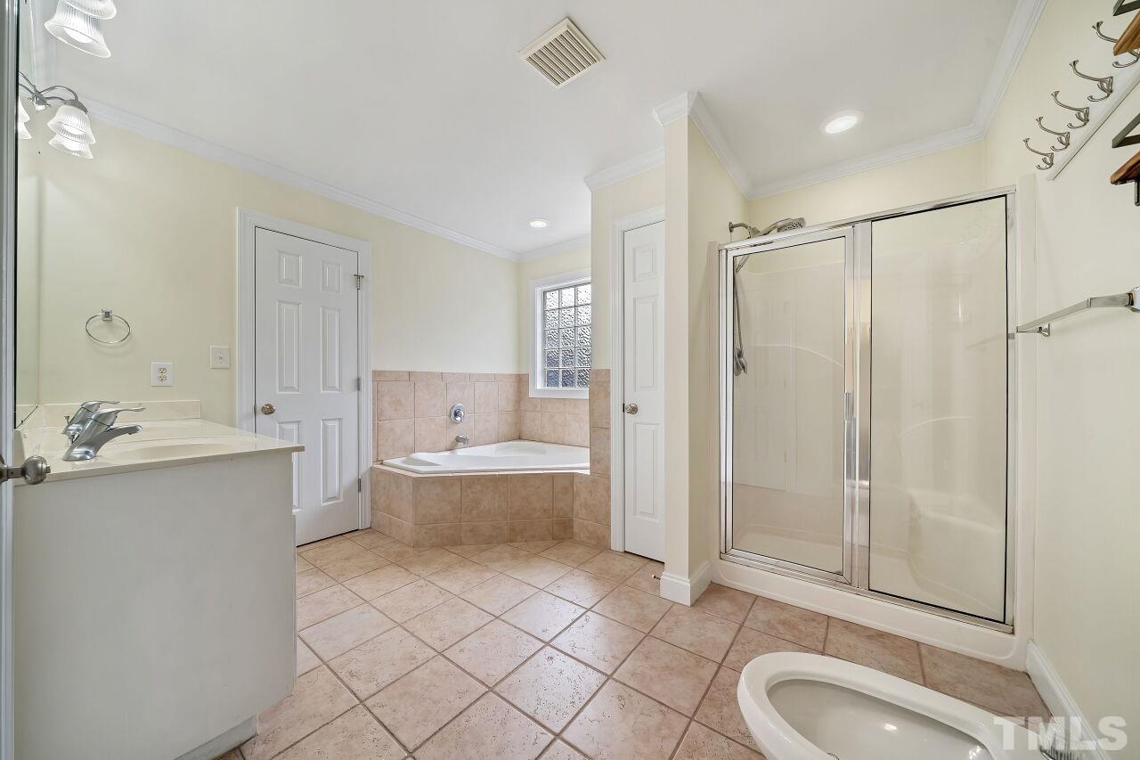 48 Eagle Pointe Lane Clayton, NC 27520 - Photo 11 of 21 a bathroom with a sink a toilet and shower