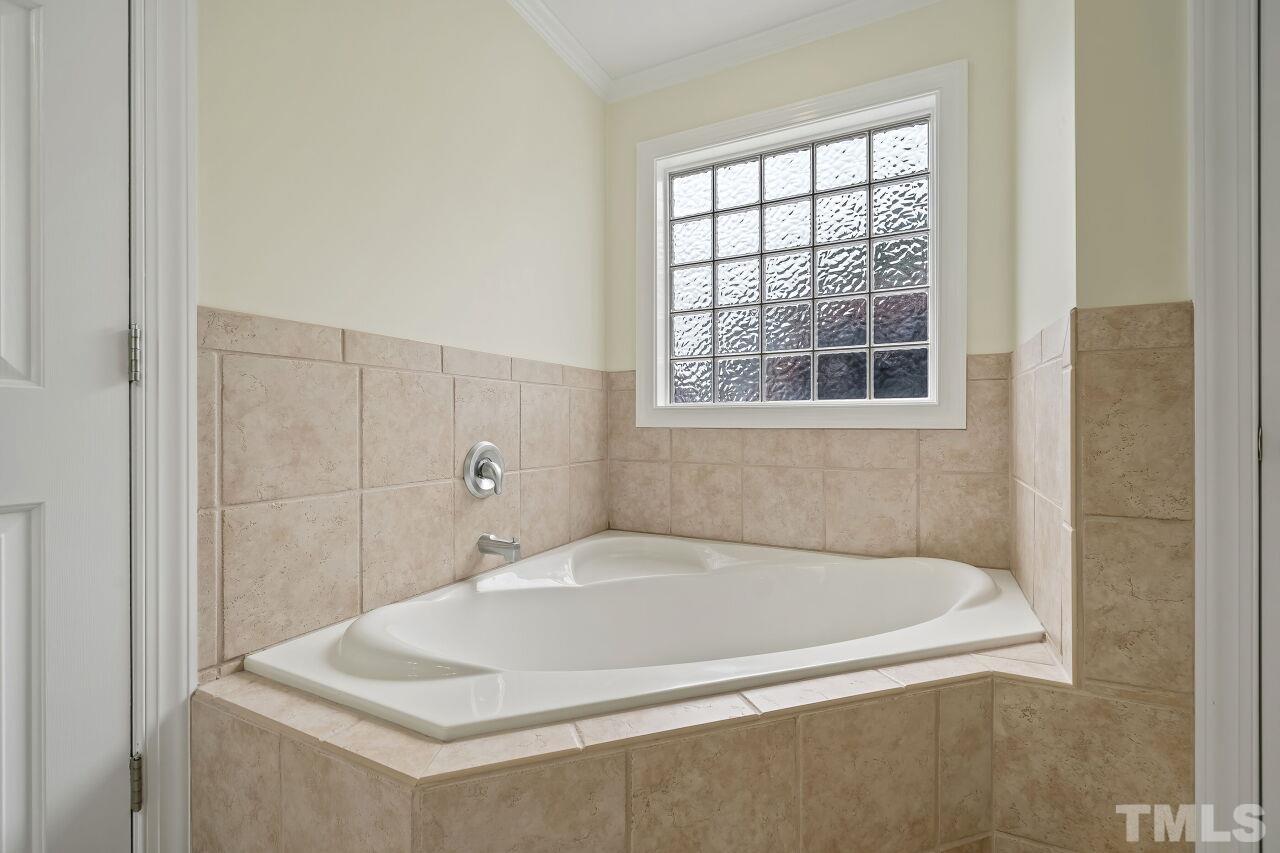 48 Eagle Pointe Lane Clayton, NC 27520 - Photo 12 of 21 a white bath tub sitting in a bathroom