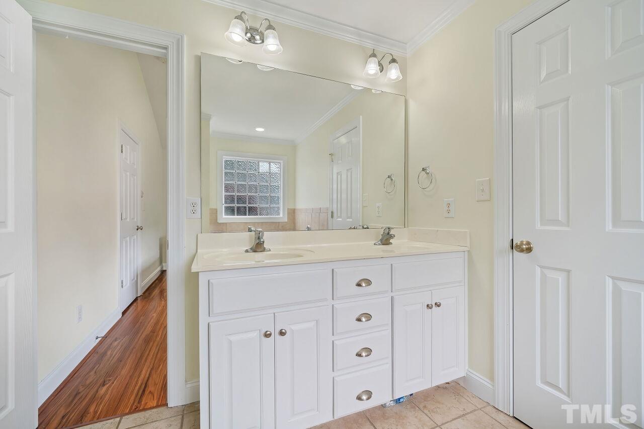 48 Eagle Pointe Lane Clayton, NC 27520 - Photo 13 of 21 a bathroom with a double vanity sink and mirror with shower
