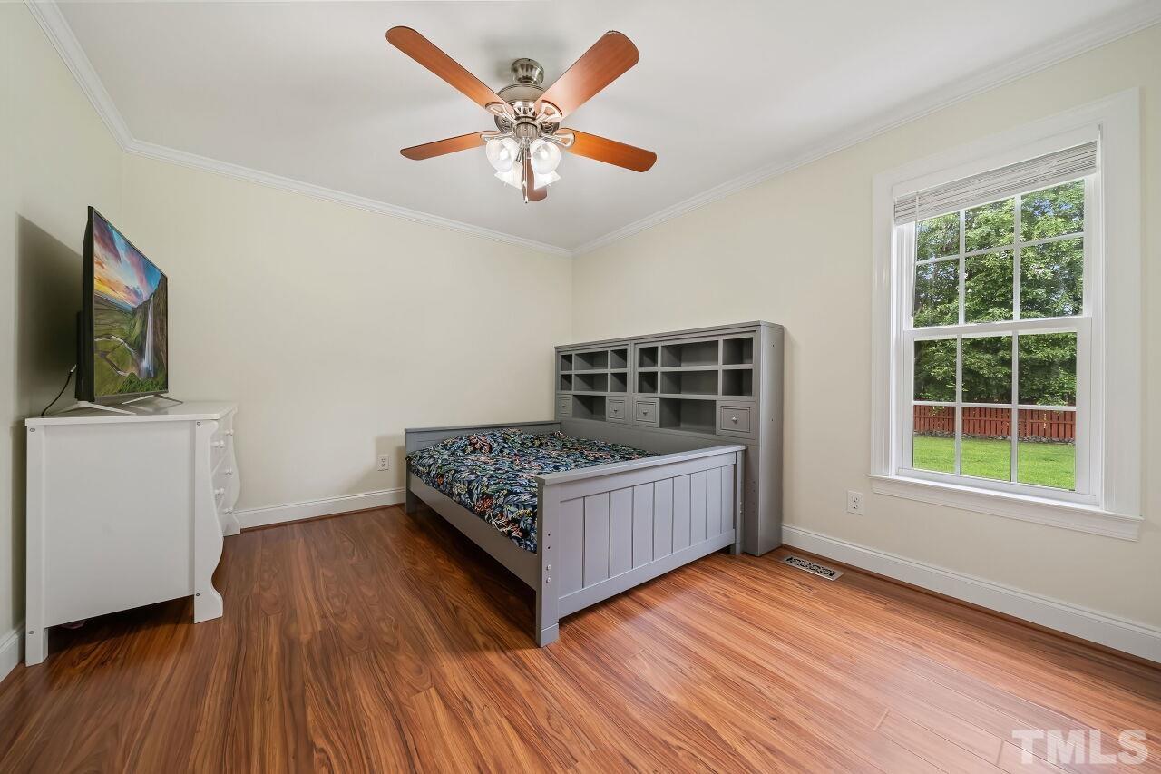 48 Eagle Pointe Lane Clayton, NC 27520 - Photo 15 of 21 a bedroom with a bed and a flat screen tv