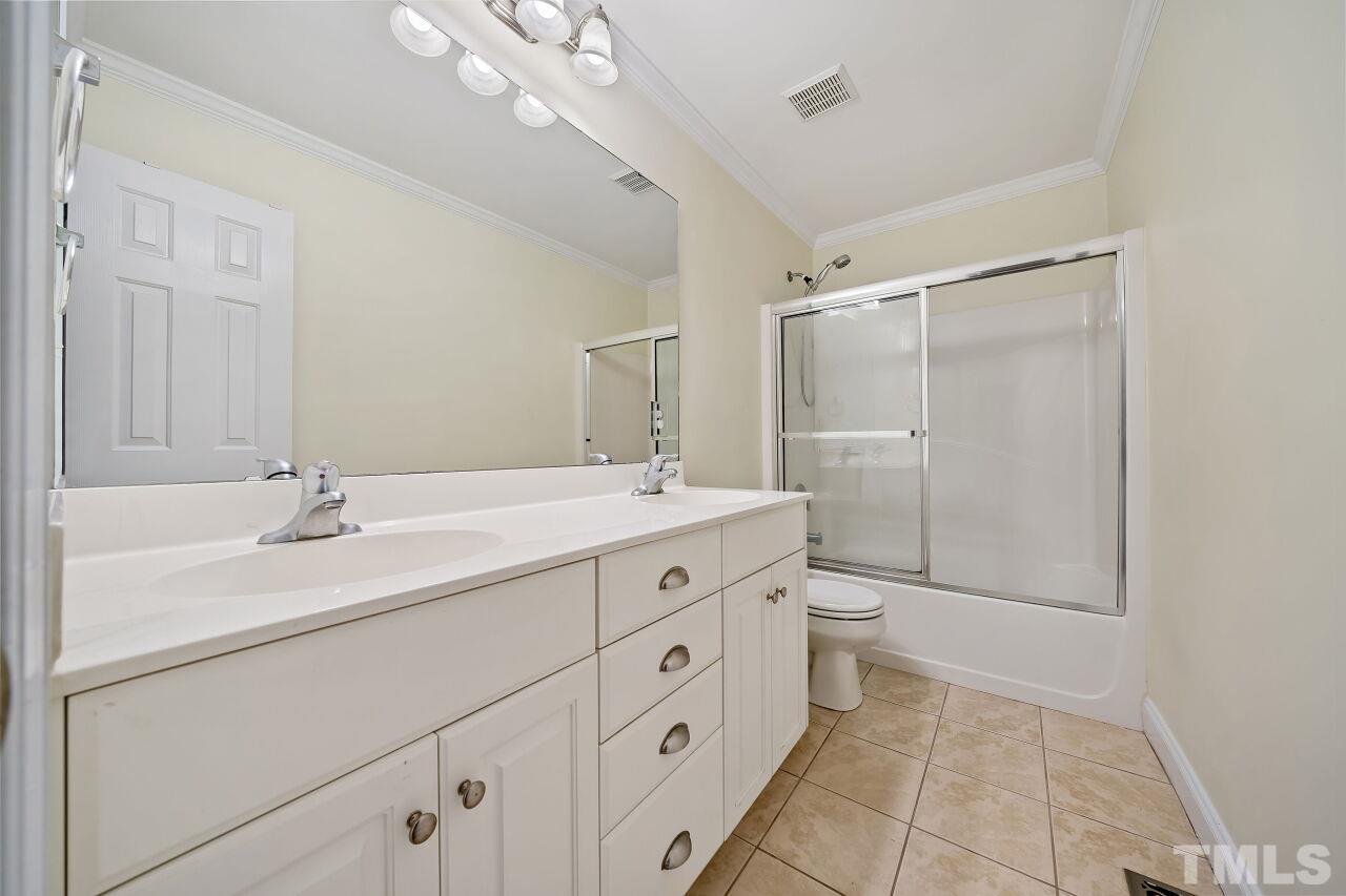 48 Eagle Pointe Lane Clayton, NC 27520 - Photo 17 of 21 a spacious bathroom with a double vanity sink a toilet and a mirror