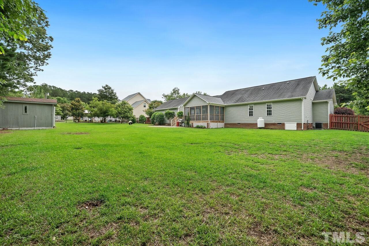 48 Eagle Pointe Lane Clayton, NC 27520 - Photo 20 of 21 a view of a house with a big yard and large trees