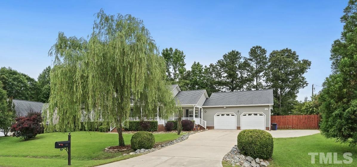 48 Eagle Pointe Lane Clayton, NC 27520 - Photo 2 of 21 a view of a big house with a big yard and potted plants and large trees
