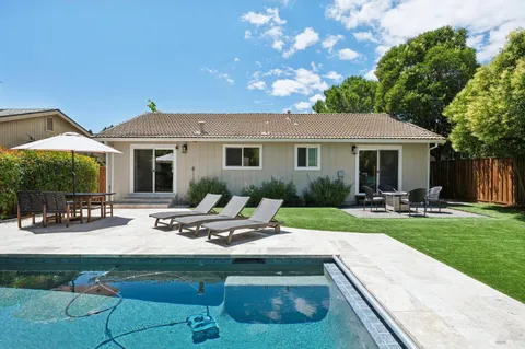 a view of a backyard with sitting area