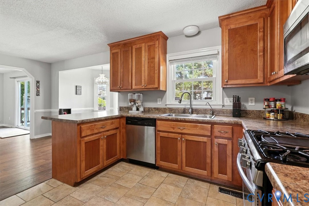 5709 Haley Lane Prince George, VA 23875 - Photo 13 of 34 a kitchen with stainless steel appliances granite countertop a sink stove and cabinets