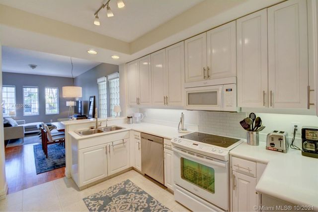 a kitchen with a sink a stove and cabinets