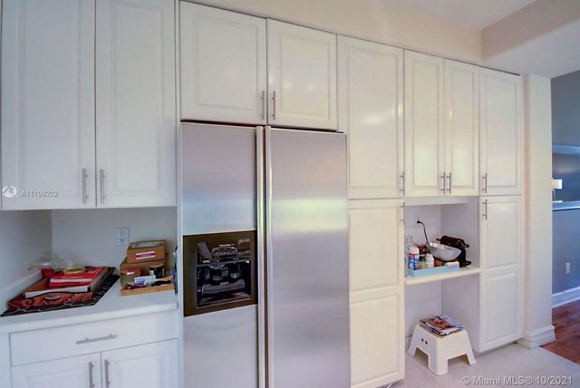 a kitchen with a refrigerator and cabinets