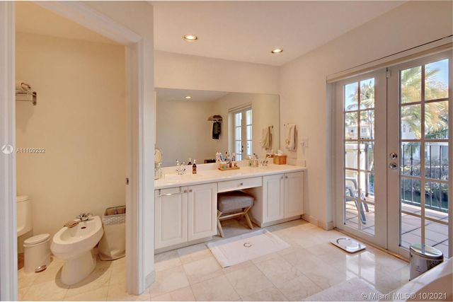 a bathroom with a sink vanity mirror and toilet