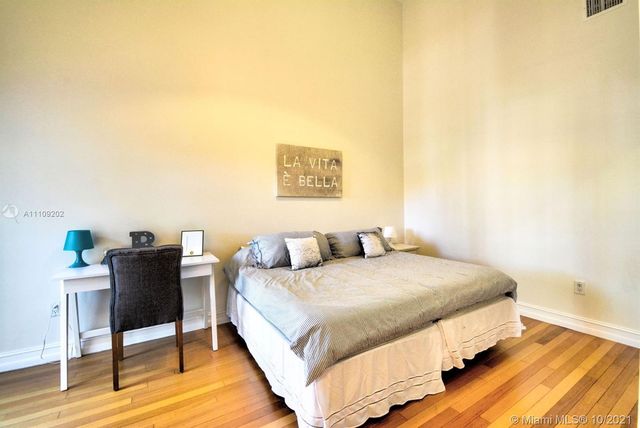 a bedroom with a bed and a table in it