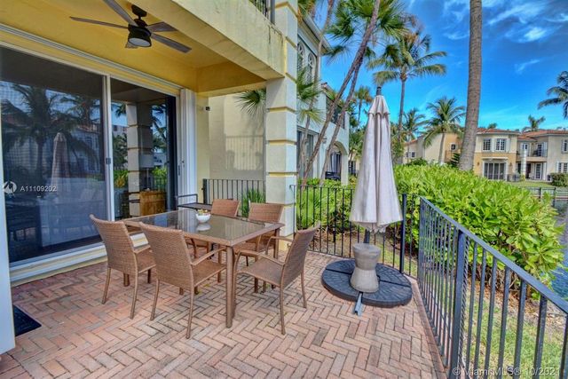 a view of a patio with couple of chairs and a fountain