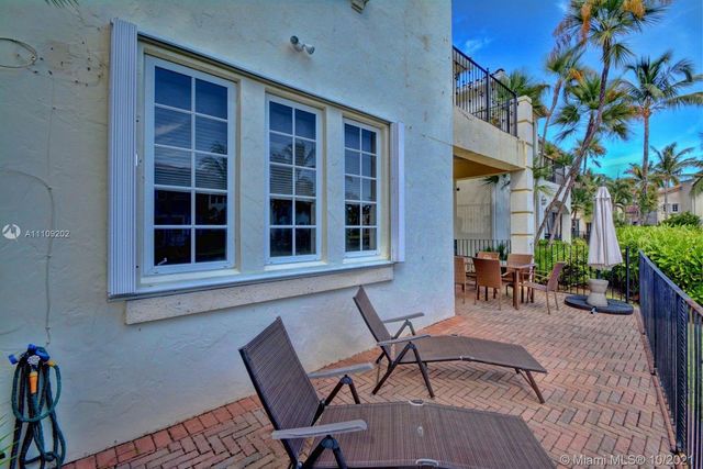a view of a house with a porch and furniture