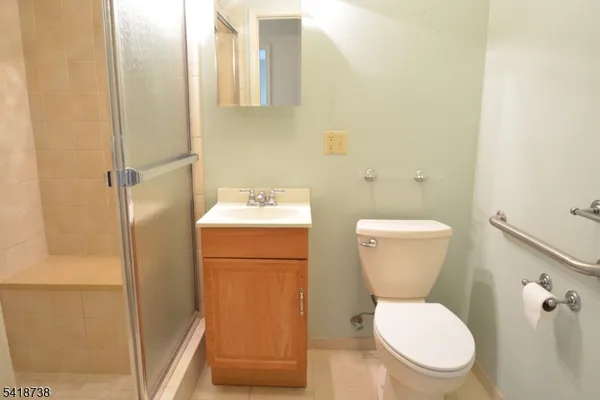a white toilet sitting next to a bathroom sink