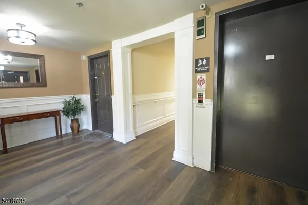 a view of livingroom with hardwood floor and front door