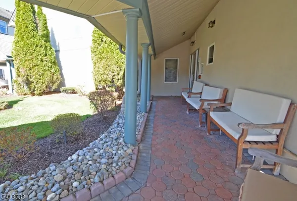 a view of a porch with chairs and backyard