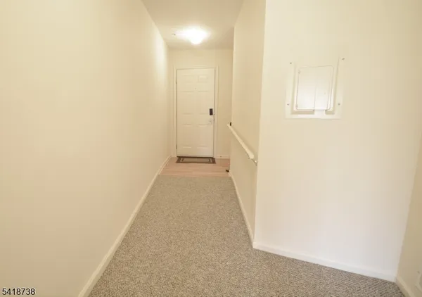 a view of a hallway with white walls