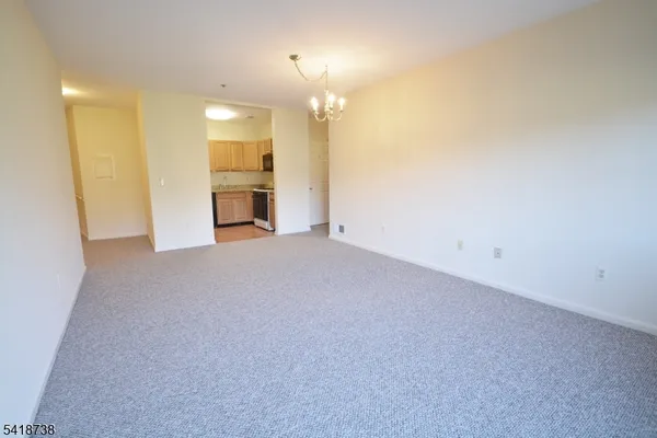 a view of a kitchen with a sink and a refrigerator