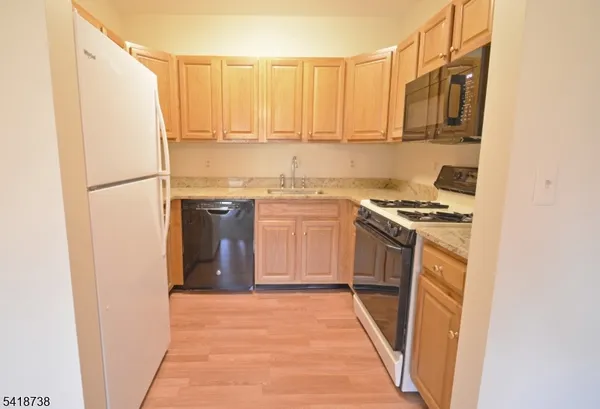 a kitchen with a sink a refrigerator and a stove