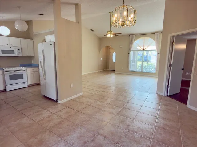 a view of a kitchen with a sink and a refrigerator