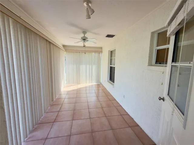 a view of empty room with windows and outdoor view