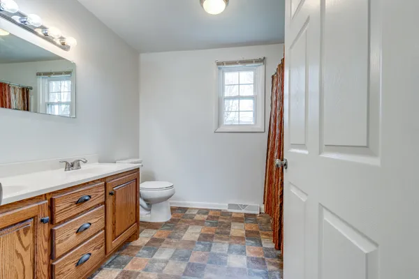 an empty room with wooden floor and a window
