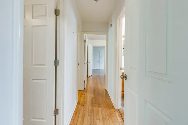 a view of empty room with wooden floor