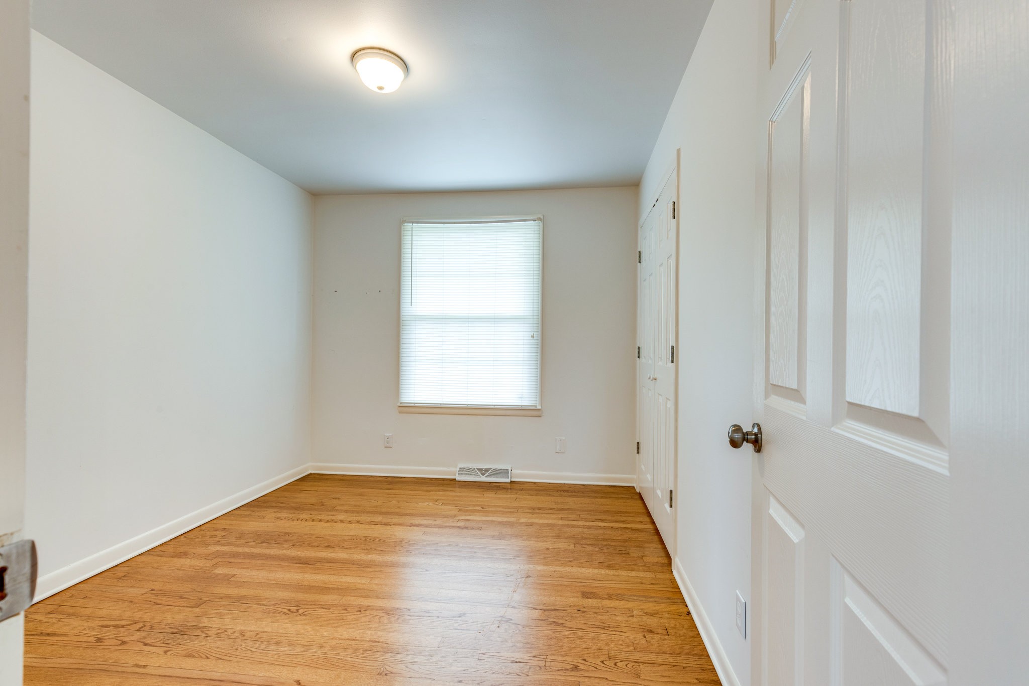 1011 Vales Mill Road Pulaski, TN 38478 - Photo 19 of 32 an empty room with wooden floor and a window