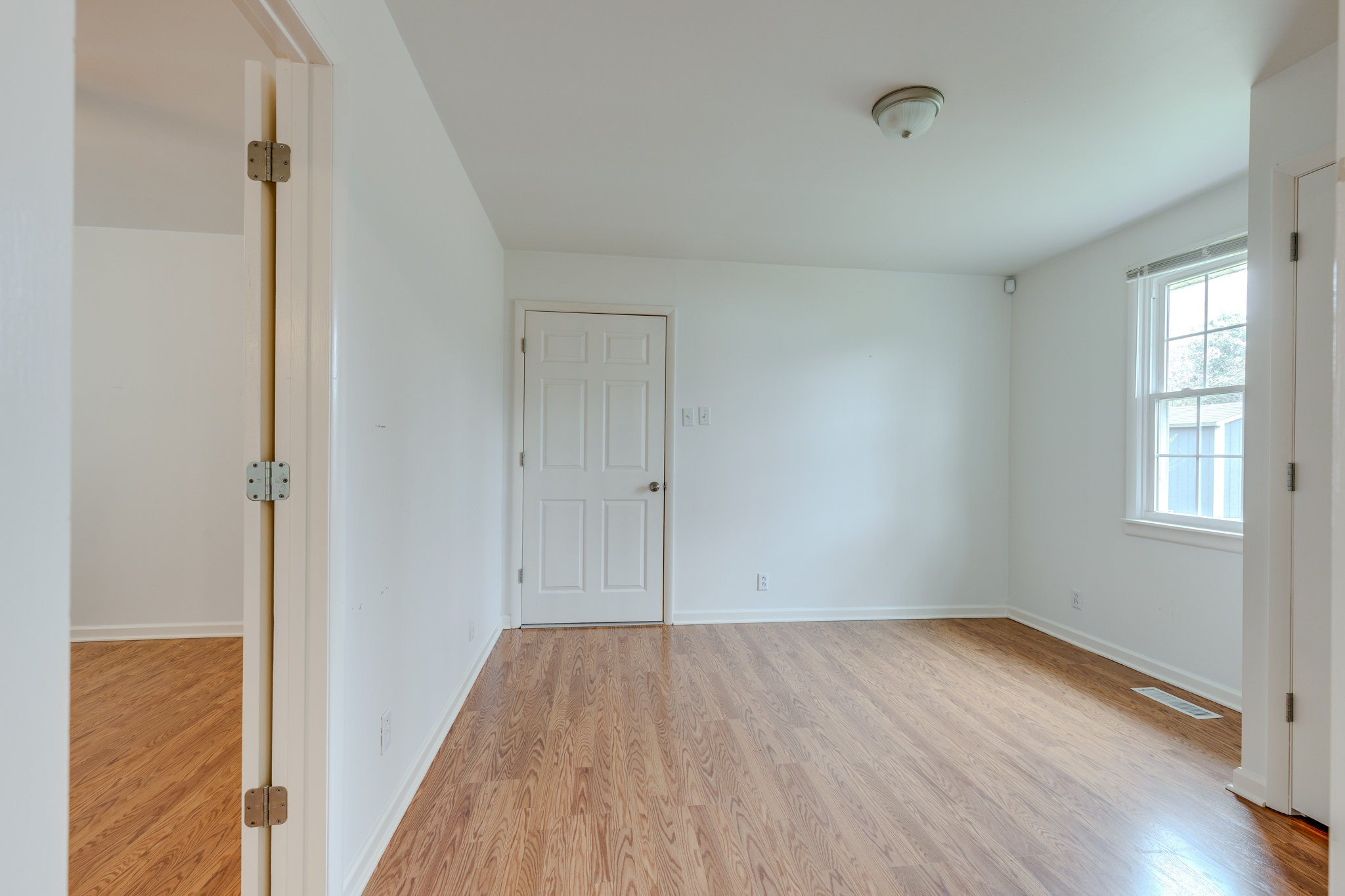 1011 Vales Mill Road Pulaski, TN 38478 - Photo 28 of 32 an empty room with wooden floor and windows