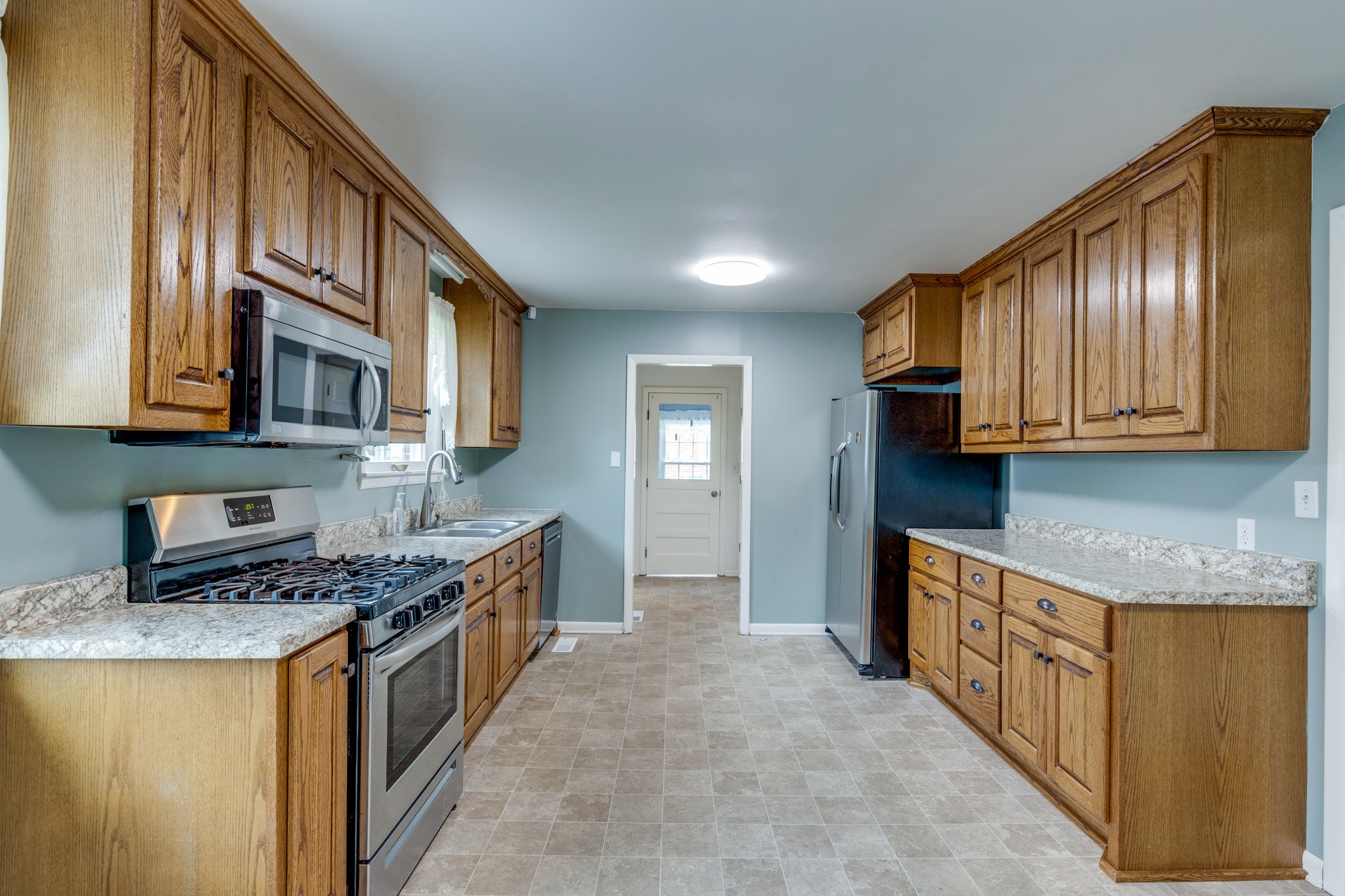 1011 Vales Mill Road Pulaski, TN 38478 - Photo 8 of 32 a kitchen with stainless steel appliances granite countertop a stove a sink and a microwave