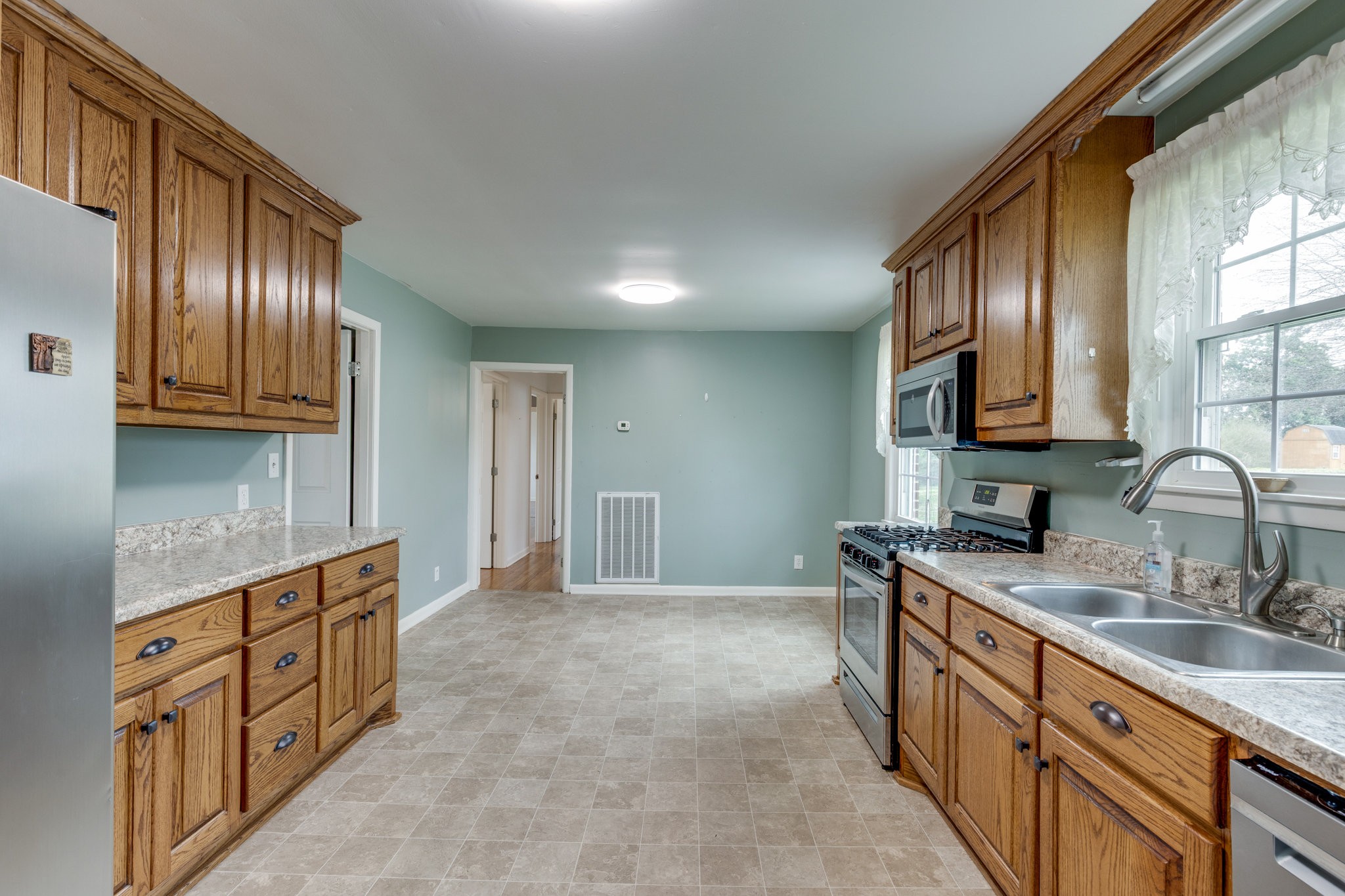 1011 Vales Mill Road Pulaski, TN 38478 - Photo 9 of 32 a kitchen with stainless steel appliances granite countertop a sink stove and cabinets