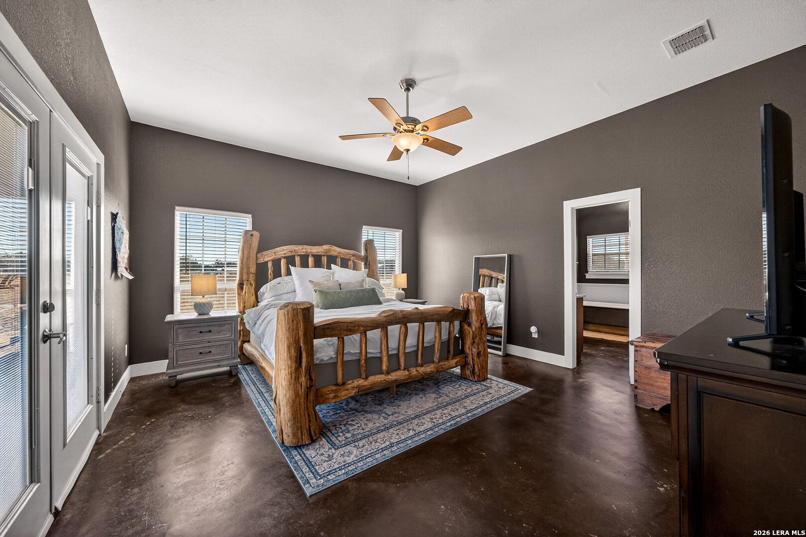 932 County Road 761 Devine, TX 78016 - Photo 21 of 47 a bedroom with a bed and a chandelier