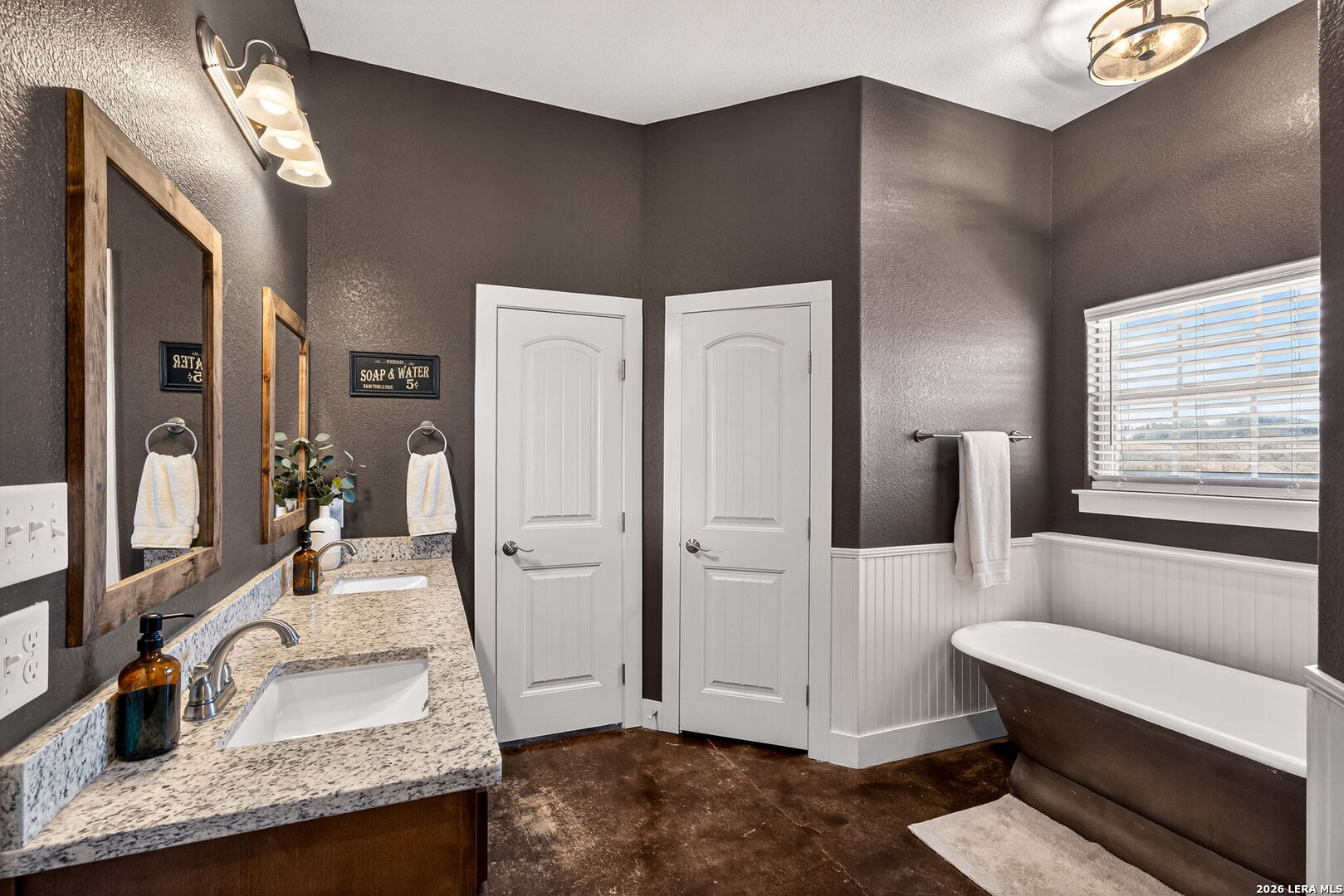 932 County Road 761 Devine, TX 78016 - Photo 23 of 47 a bathroom with a granite countertop sink and a mirror