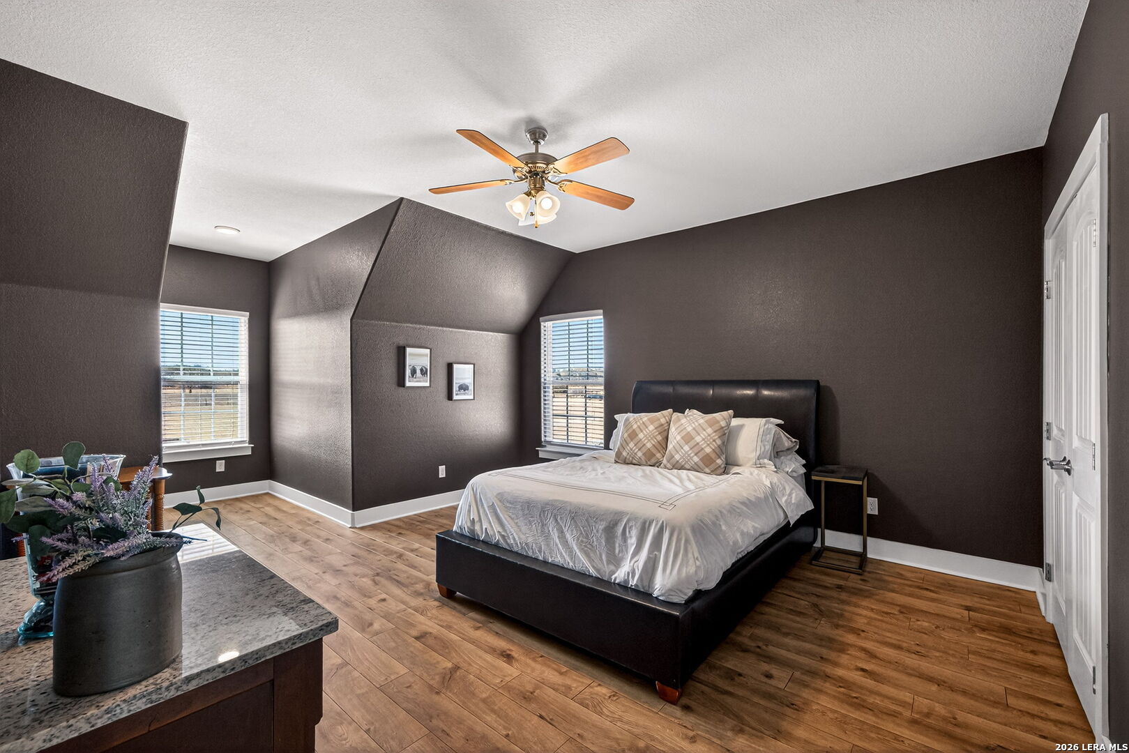 932 County Road 761 Devine, TX 78016 - Photo 29 of 47 a bedroom with a bed and wooden floor