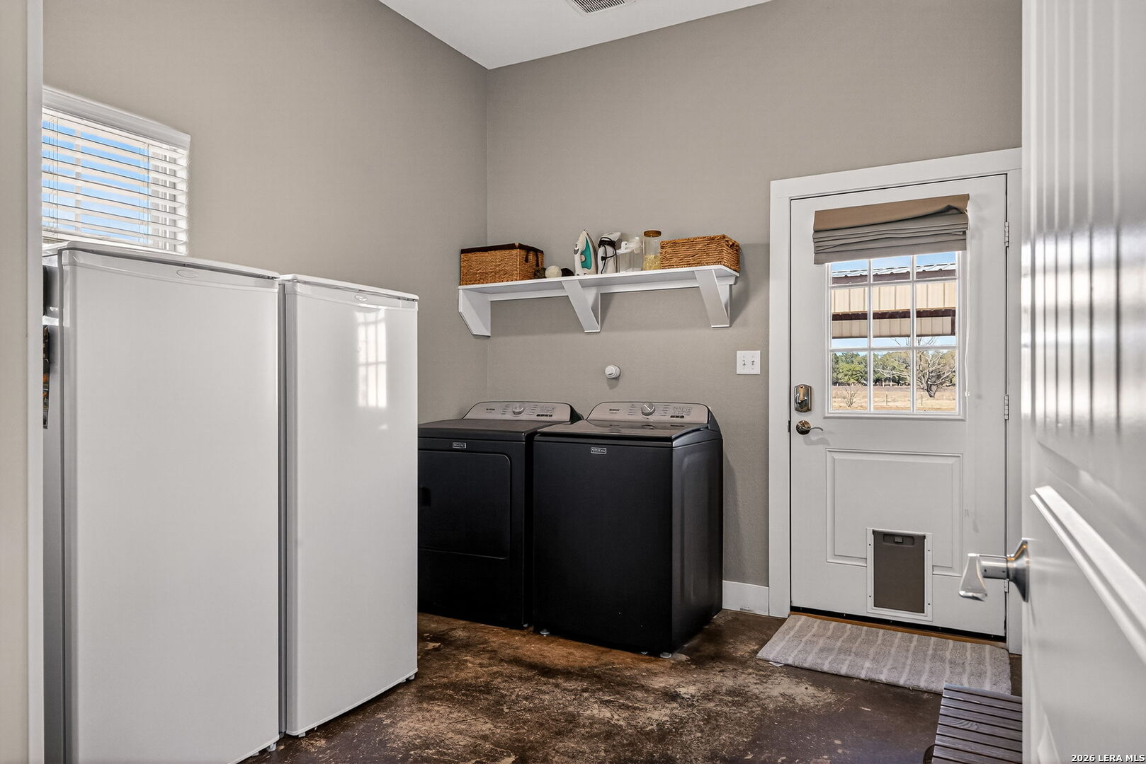 932 County Road 761 Devine, TX 78016 - Photo 34 of 47 a utility room with cabinets washer and dryer