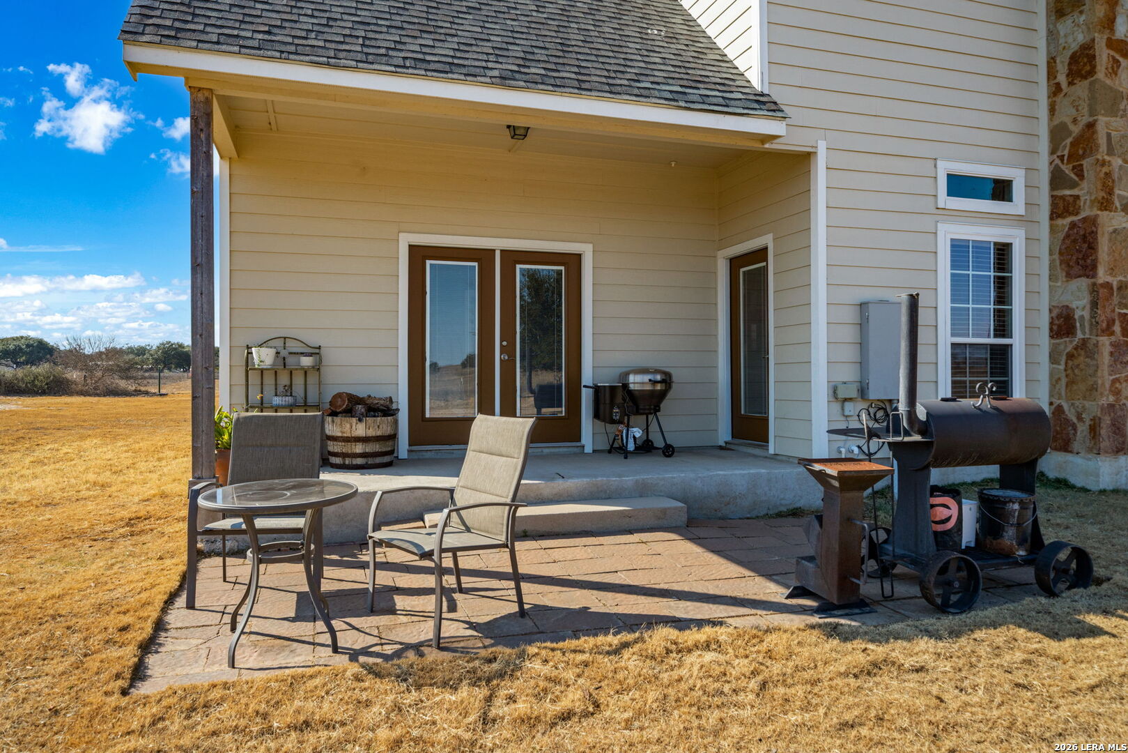 932 County Road 761 Devine, TX 78016 - Photo 35 of 47 a view of a patio with table and chairs near an umbrella