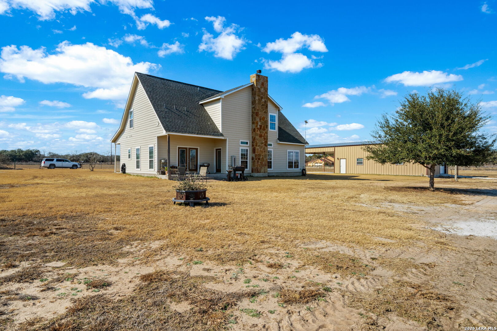 932 County Road 761 Devine, TX 78016 - Photo 36 of 47 a view of a house with a yard