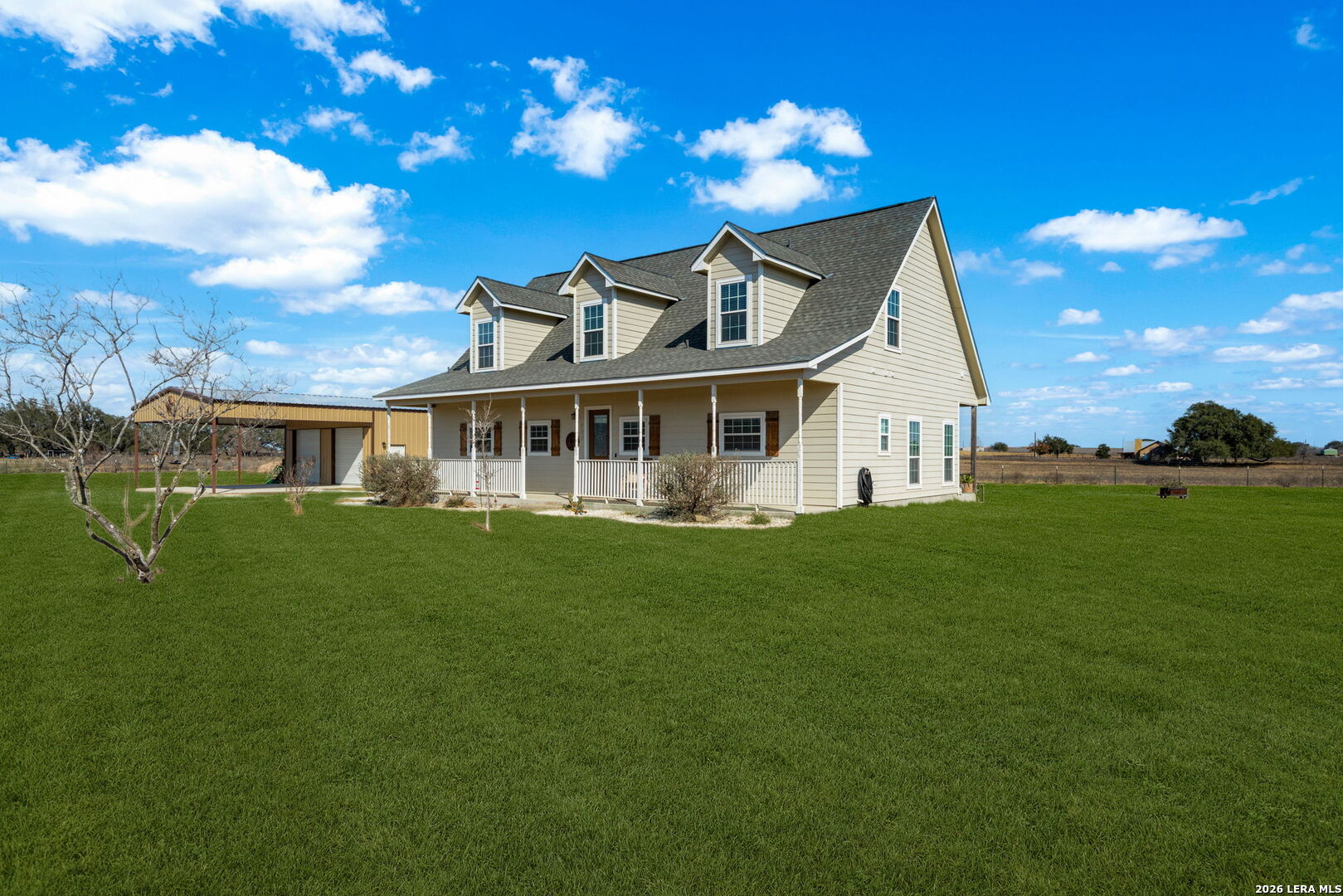932 County Road 761 Devine, TX 78016 - Photo 6 of 47 a front view of a house with a garden