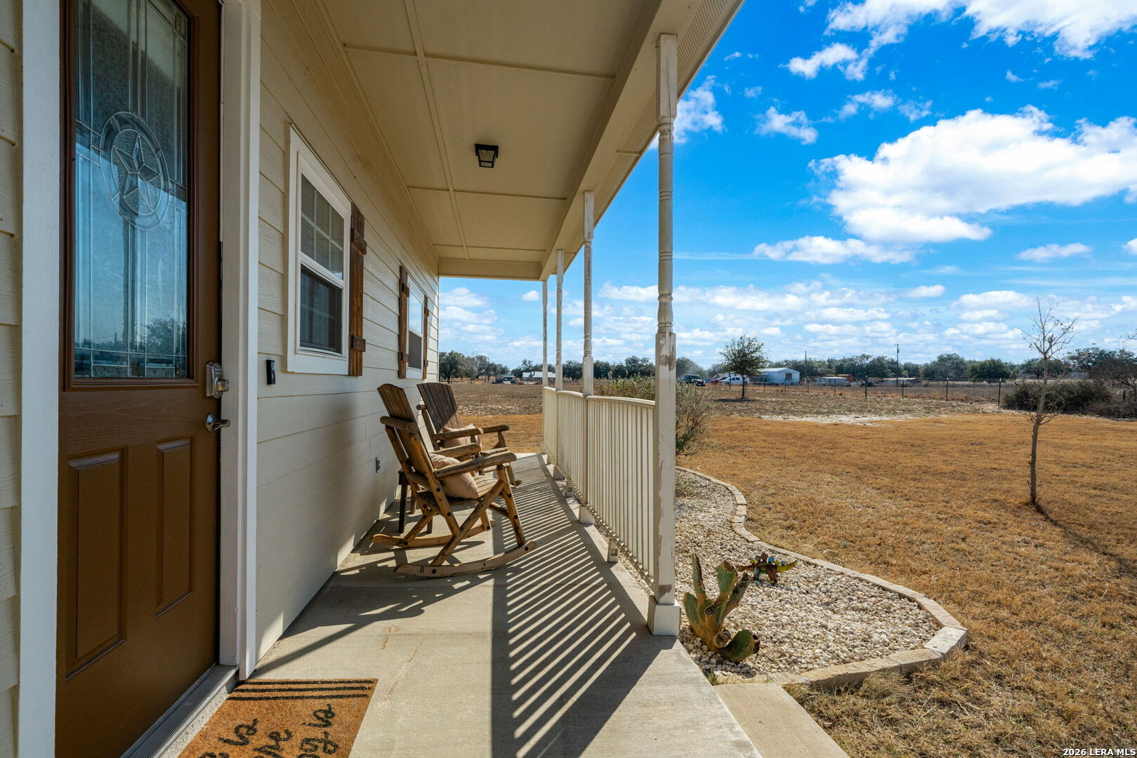 932 County Road 761 Devine, TX 78016 - Photo 7 of 47 a view of a balcony with chair and wooden floor
