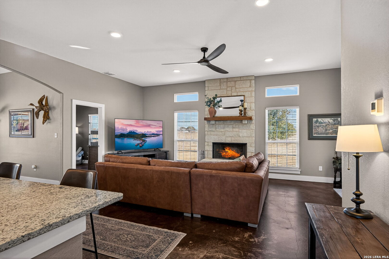932 County Road 761 Devine, TX 78016 - Photo 10 of 47 a living room with furniture a fireplace and a flat screen tv
