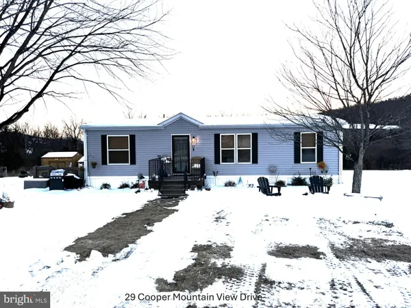 a view of a house with snow on the side of the road