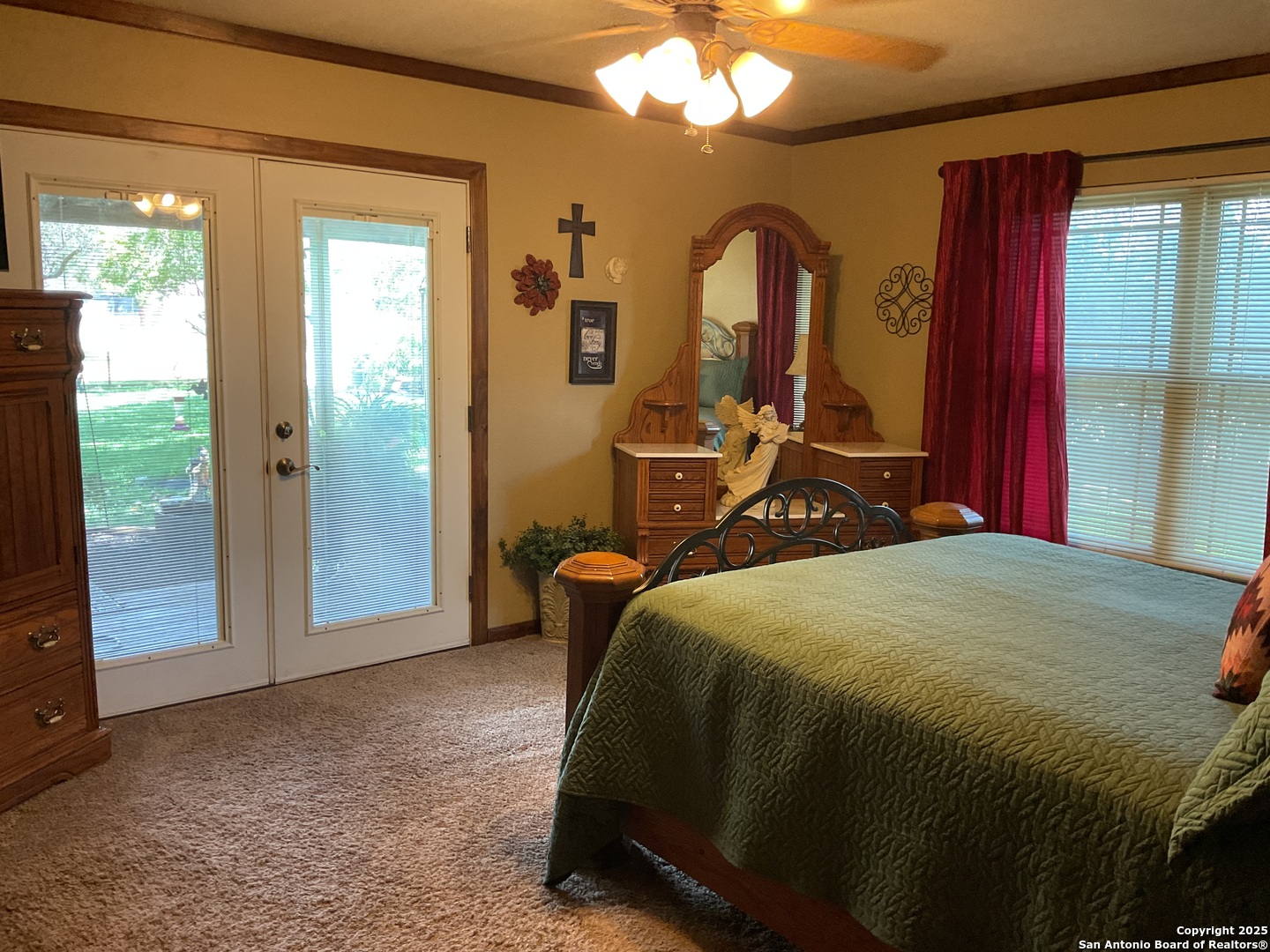 1408 Libold Drive Devine, TX 78016 - Photo 13 of 32 a bed sitting in a bedroom next to a window