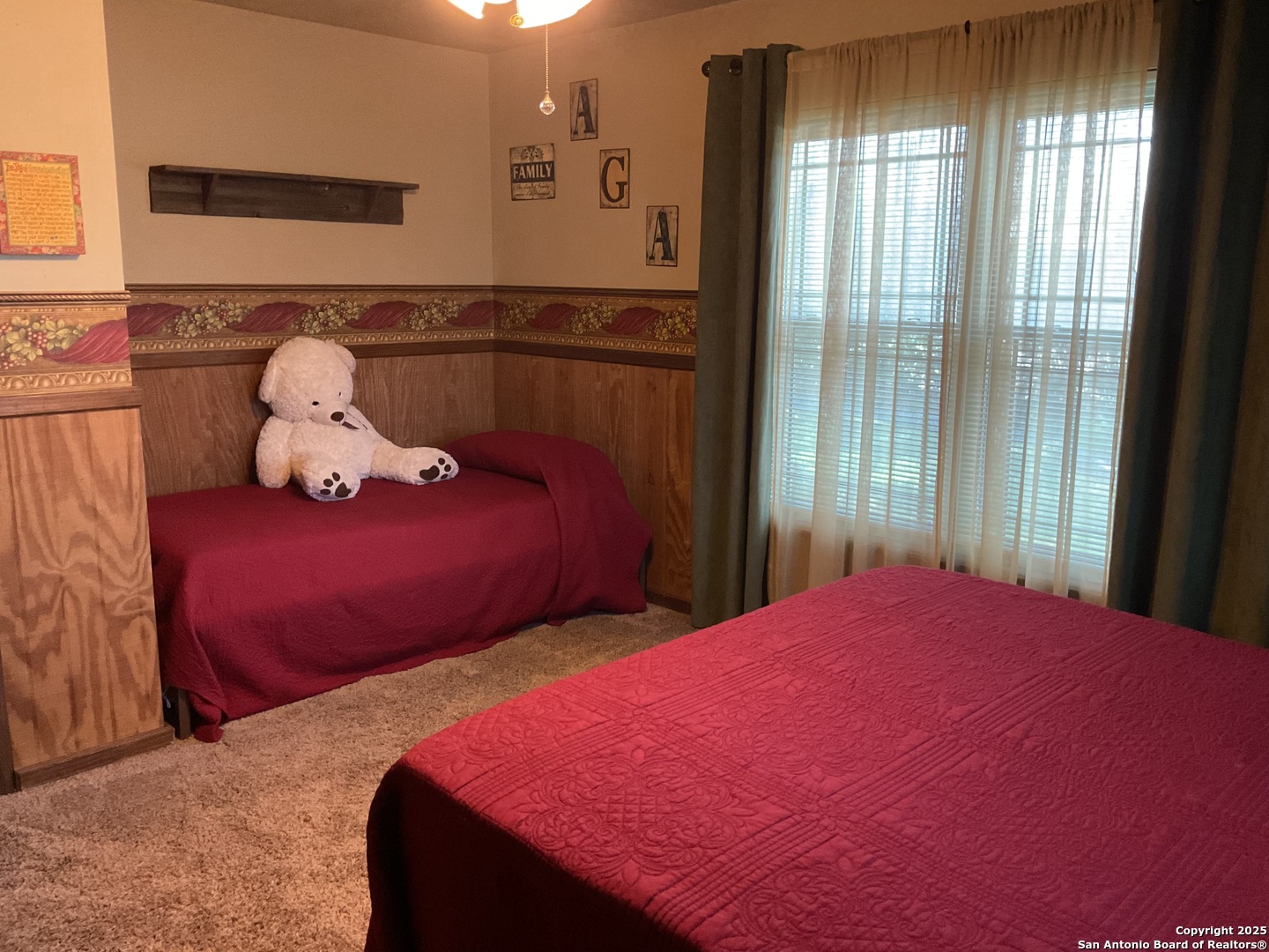 1408 Libold Drive Devine, TX 78016 - Photo 20 of 32 a bedroom with two beds and a window